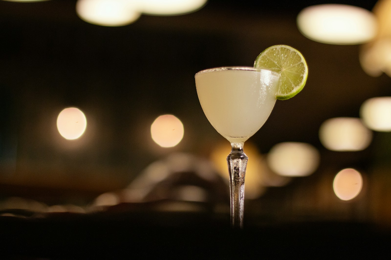 A lime-garnished margarita in warm evening light